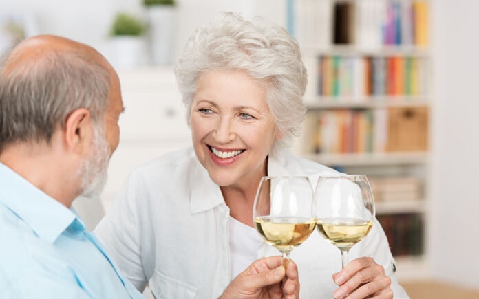 Happy,Senior,Couple,Celebrating,Clinking,Their,Glasses,Of,White,Wine